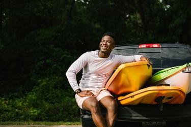 Young man enjoying his new truck during summer